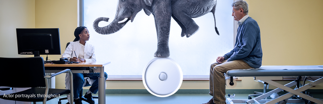Doctor and patient sitting in office with an elephant balancing on a ball between them