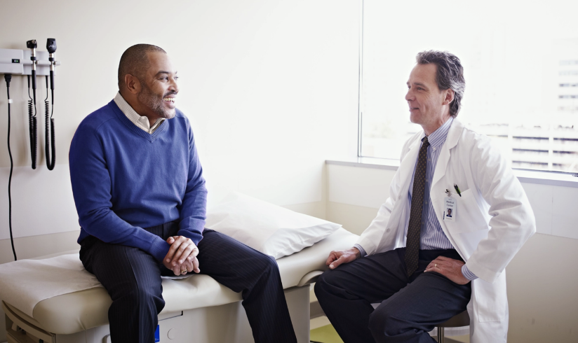 Male patient and doctor talking in office